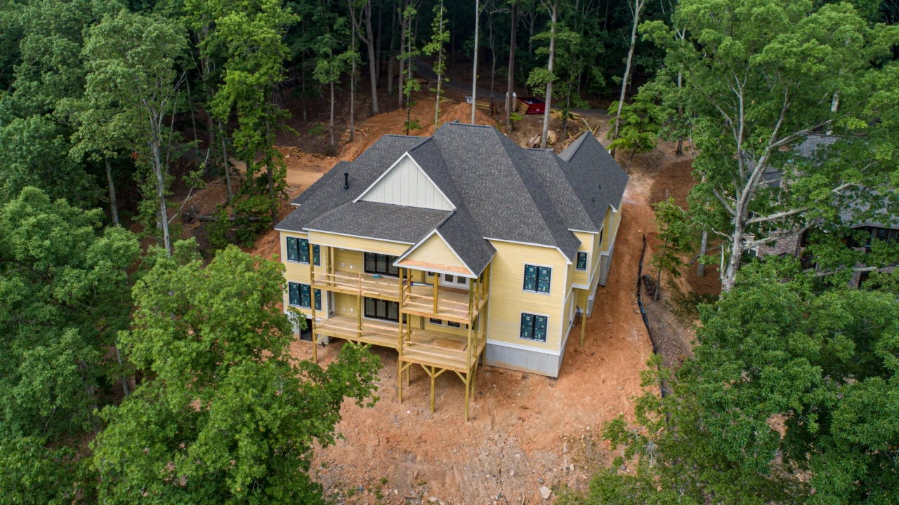 A new home under construction surrounded by trees